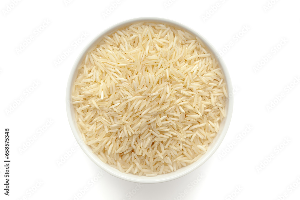 Organic White rice (Oryza sativa) in a white ceramic bowl. Isolated on a white background. Top View Organic White rice (Oryza sativa) in a white ceramic bowl. Isolated on a white background. Top View