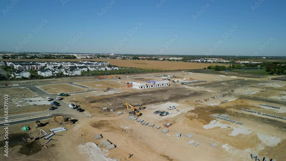 Aerial wide shot of suburb in pre construction empty lots and home