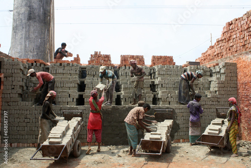 Bangladeshi manual laborers are working at a brick-field on the outskirts of Dhaka. They often earn less then US$5 per day..About 6000-7000 brick-fields in Bangladesh. photo