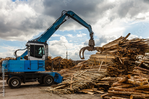 Log loader or forestry machine loads a log truck