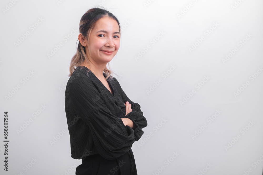 Portrait of Asian businesswoman in black casual wear cross her arm and looking at camera on grey background. Success and positive girl professional manager smile and happy about her work job. Portrait of Asian businesswoman in black casual wear cross her arm and looking at camera on grey background. Success and positive girl professional manager smile and happy about her work job.