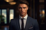 A confident and stylish man dressed in a suit and tie poses for a professional portrait. Perfect for business-related projects and corporate presentations.