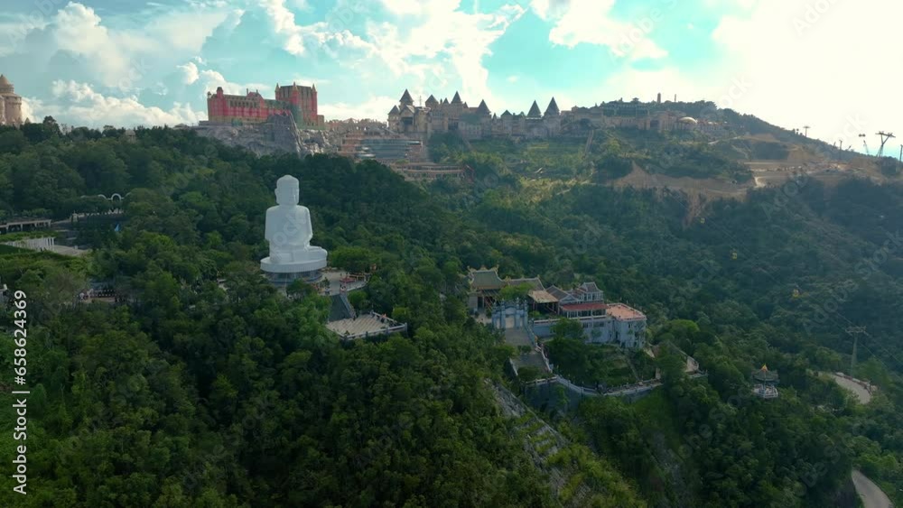 Aerial view of Linh Ung Pagoda with a giant buddha statue among on the top of Ba Na mountain. Near Golden bridge. Da Nang, Vietnam and castles at the top of Bana Hills, the famous tourist Aerial view of Linh Ung Pagoda with a giant buddha statue among on the top of Ba Na mountain. Near Golden bridge. Da Nang, Vietnam and castles at the top of Bana Hills, the famous tourist