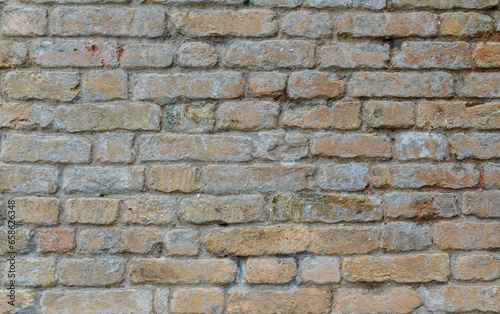 Grunge brick wall of an ancient Venetian building for your background. Italian architecture and heritage.
