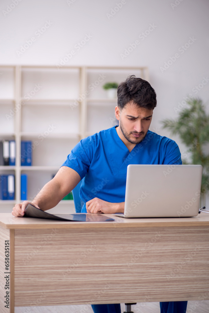 Fototapeta premium Young male doctor in telemedicine concept