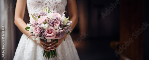 Beautiful pastel wedding bouquet in bride's hands, bokeh background.