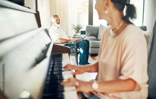 Senior woman playing piano for music in living room for bonding  entertainment or having fun. Happy  smile and elderly Asian female person with husband in retirement enjoying keyboard at modern home.
