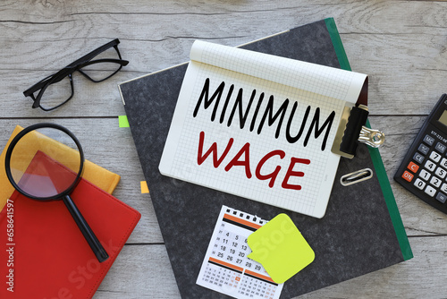 Wallpaper Mural Minimum Wage text on a notebook on a folder. red notepad. magnifying glass Torontodigital.ca