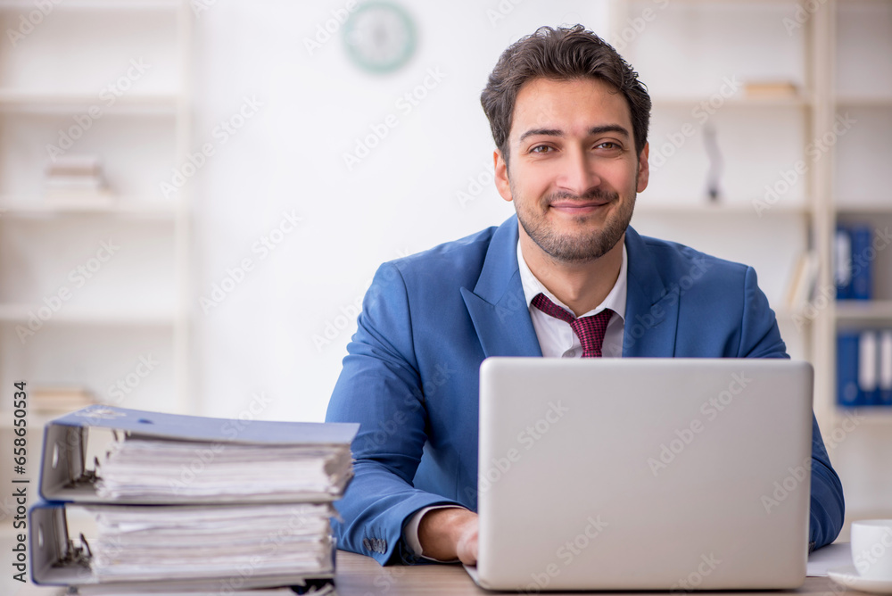 Young male employee working in the office Young male employee working in the office