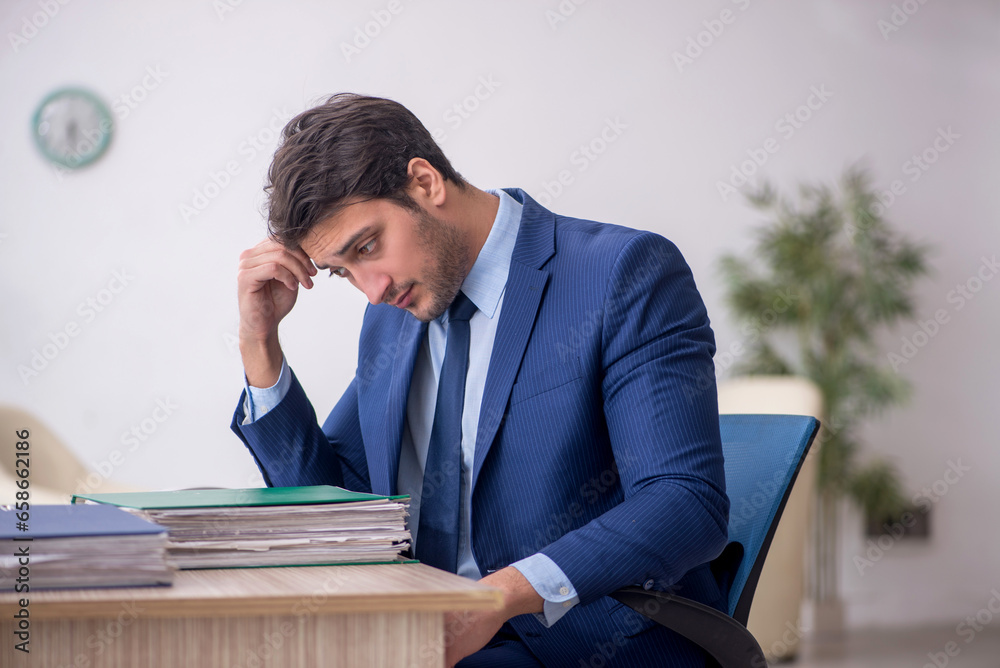 Young male employee working in the office Young male employee working in the office