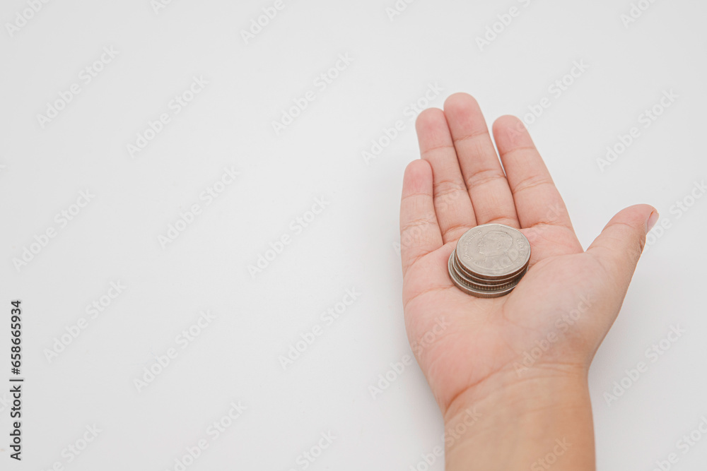 Child hand holding coin on white background, save money for prepare in the future. Copy space for your text Child hand holding coin on white background, save money for prepare in the future. Copy space for your text