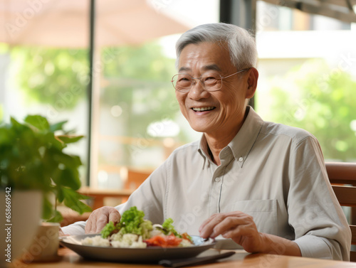 Happy elderly Asian man enjoying healthy lunch outdoors  health and happiness concept