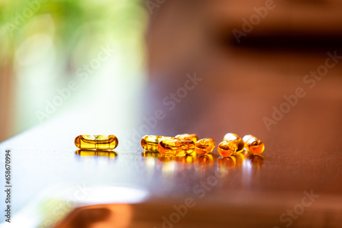 Multiple capsules with coenzyme Q10 coq10 on a kitchen counter