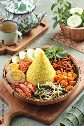 Obraz na plátně Tumpeng is an Indonesian cone-shaped rice dish with side dishes of vegetables and meat originating from Javanese cuisine of Indonesia