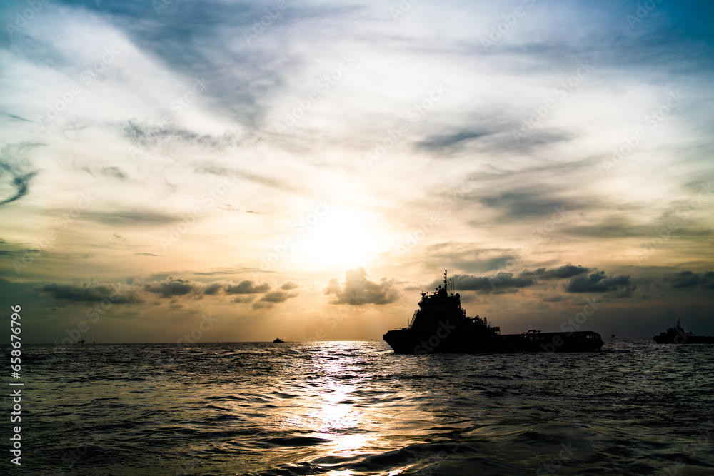 Φωτογραφία Transport ship of offshore gas and oil drilling platform in petroleum industry at sunrise morning