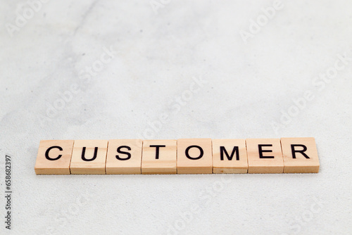 Top view of Customer word on wooden cube letter block on white background. Business concept
