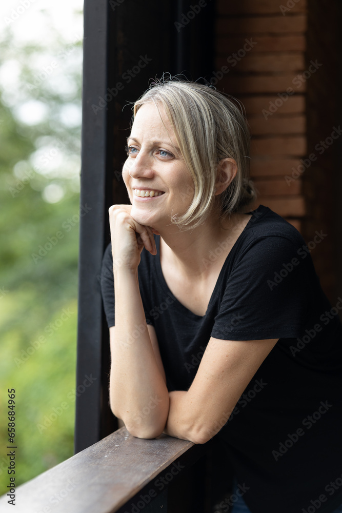 Woman looking out the window smiling