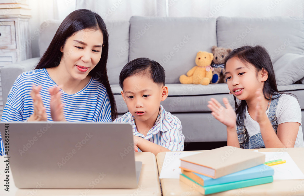 Happy family Mom and sister clapping hands for encouraging son during doing homework on laptop computer Happiness love family doing activity together at home They having fun and cheering to Happy family Mom and sister clapping hands for encouraging son during doing homework on laptop computer Happiness love family doing activity together at home They having fun and cheering to