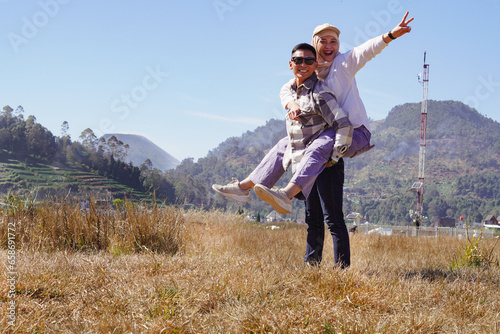 Young Asian Couple of tourists having fun on summer vacation. Couple laughing together on vacation - People and holidays concept