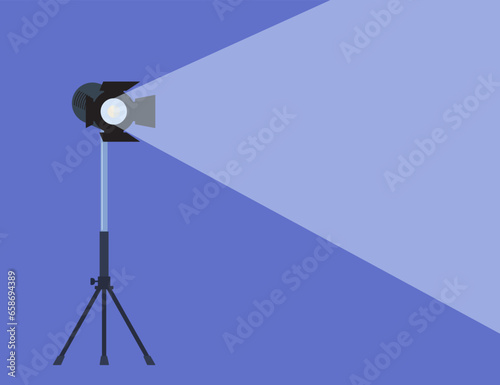 Cinema spotlight. Lamp projector on a tripod with scattered rays. Light source, studio lighting. Equipment for filming. Vector illustration.