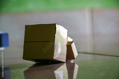 Cardboard box on the floor, close-up, shallow depth of field