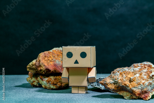 Wooden robot with stones on dark background, artificial intelligence concept
