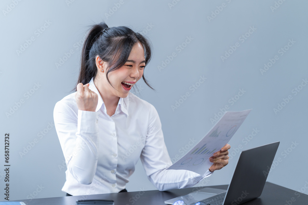 Portrait of a happy beautiful Asian businesswoman. Working with a laptop and Mobilphone in a company office Portrait of a happy beautiful Asian businesswoman. Working with a laptop and Mobilphone in a company office
