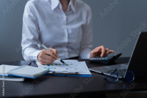 Asian businessman using laptop computer and smartphone contact business search information on desk in the office. checks mail,  © Tj