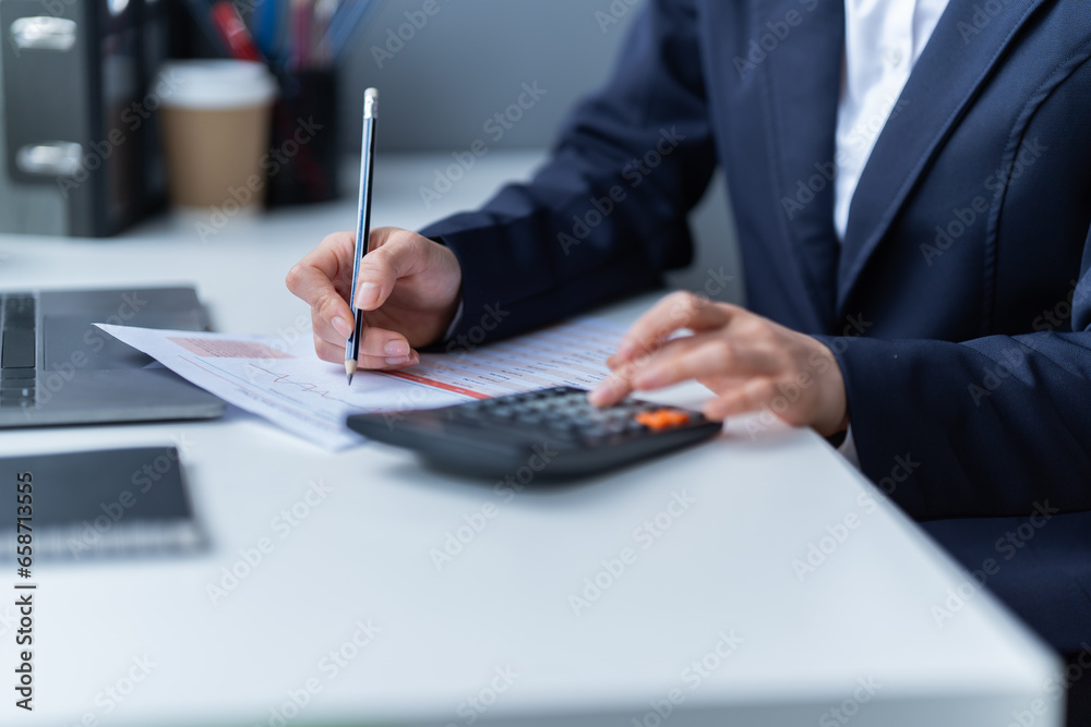 Asian businessman using laptop computer and smartphone contact business search information on desk in the office. checks mail, Asian businessman using laptop computer and smartphone contact business search information on desk in the office. checks mail,