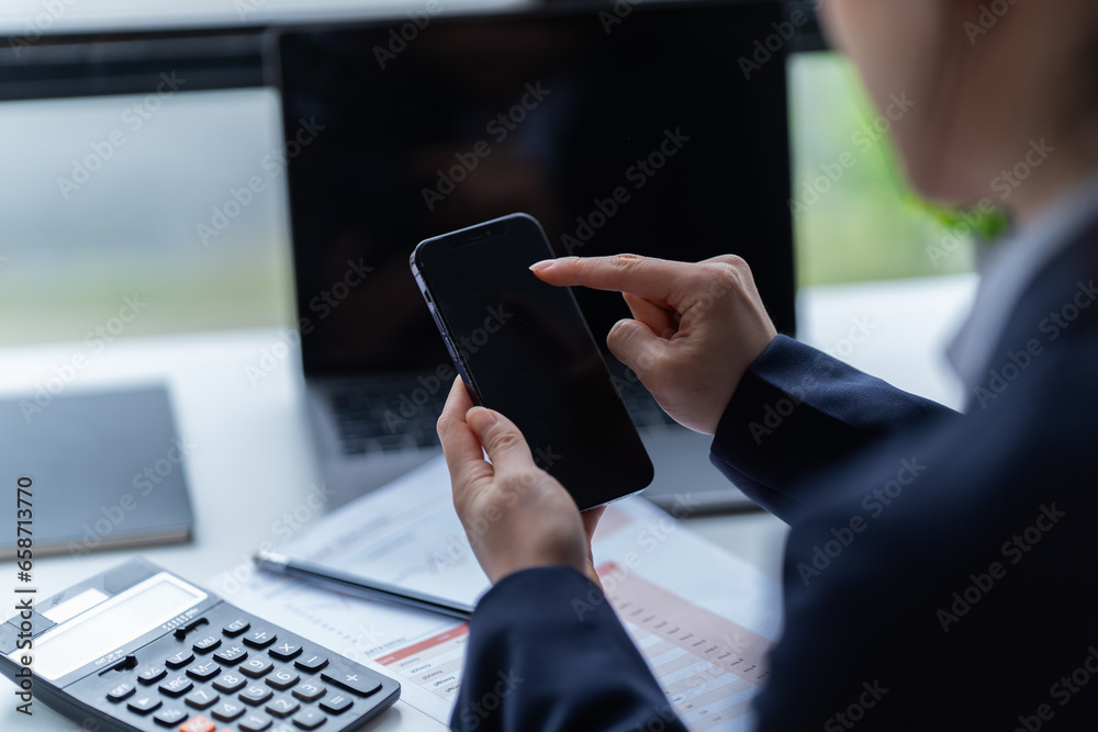 Asian businessman using laptop computer and smartphone contact business search information on desk in the office. checks mail, Asian businessman using laptop computer and smartphone contact business search information on desk in the office. checks mail,