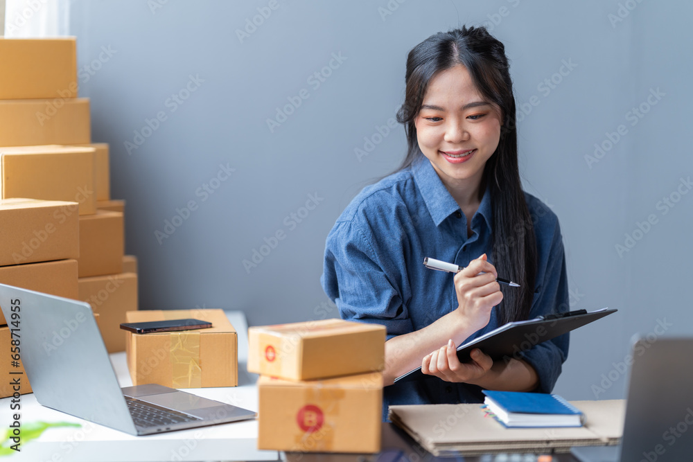 startup girl Small SME business owners work with laptop computers at work. with parcel paper boxes for delivery to customers online selling, Ecommerce, startup girl Small SME business owners work with laptop computers at work. with parcel paper boxes for delivery to customers online selling, Ecommerce,