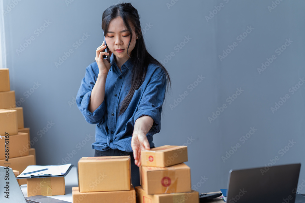 startup girl Small SME business owners work with laptop computers at work. with parcel paper boxes for delivery to customers online selling, Ecommerce, startup girl Small SME business owners work with laptop computers at work. with parcel paper boxes for delivery to customers online selling, Ecommerce,
