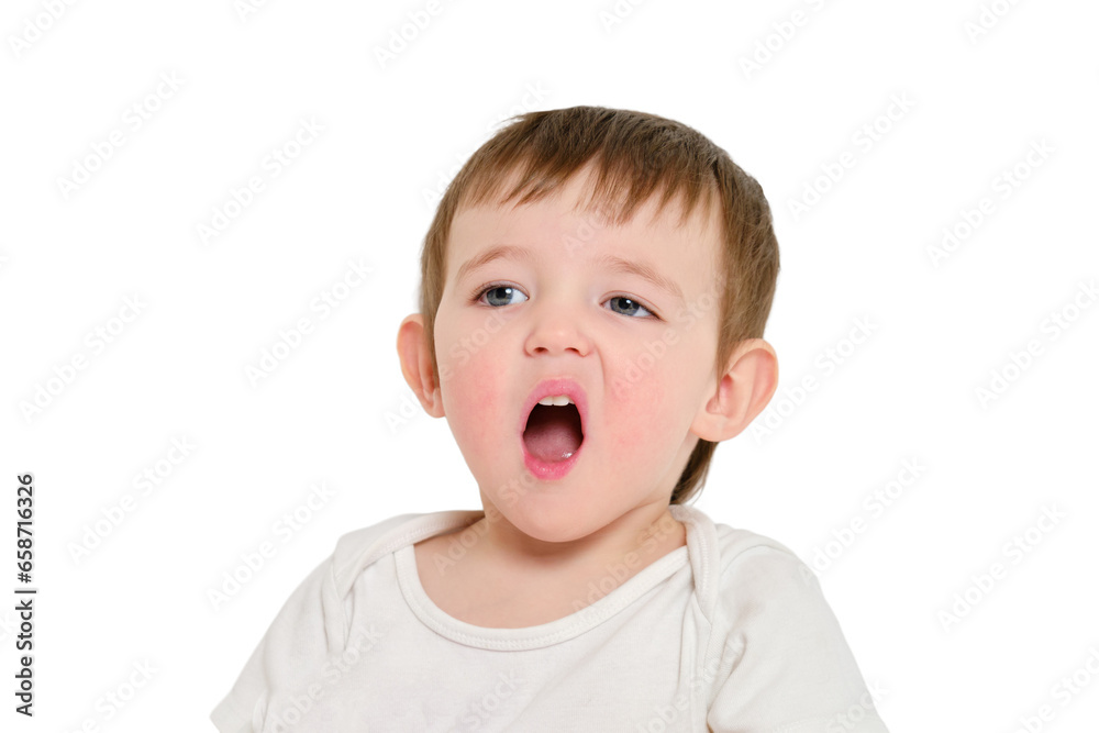 Bored baby yawns with open mouth, studio, isolated on white background. Screaming child with an emotion of displeasure on his face. Kid about two years old (one year nine months)