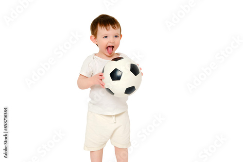 Happy baby holding a soccer ball on a studio, isolated on white background. Smiling child playing football, isolated on white background. Kid about two years old (one year nine months) © Андрей Журавлев
