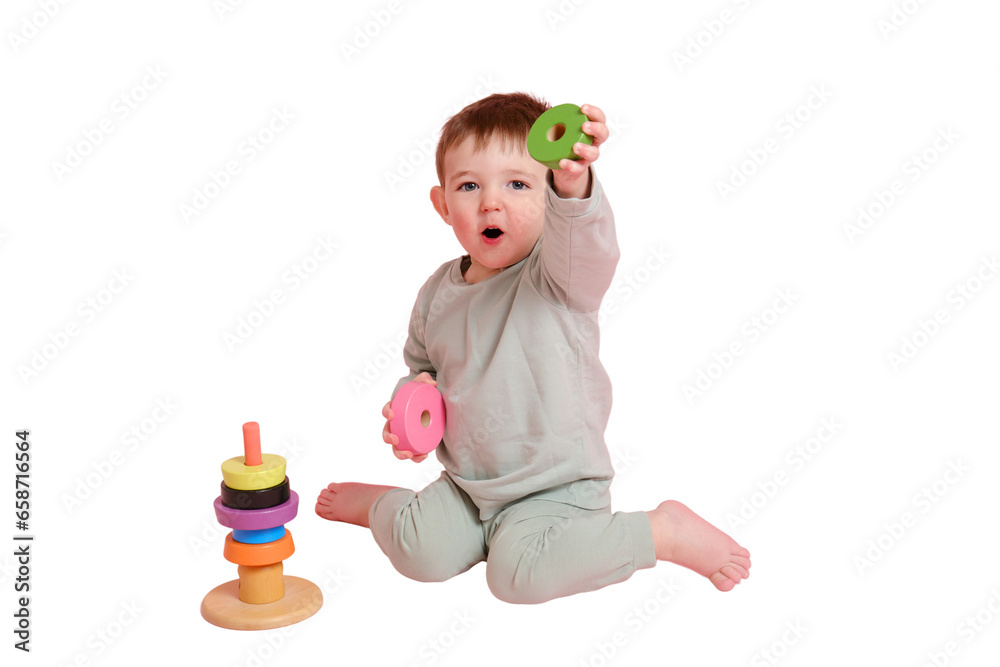 Happy toddler baby plays with a pyramid on a studio, isolated on white background. Child boy puts wooden rings on a toy pyramid. Kid age one year eight months, full height Happy toddler baby plays with a pyramid on a studio, isolated on white background. Child boy puts wooden rings on a toy pyramid. Kid age one year eight months, full height