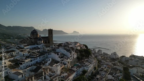 Aerial view Church of Our Lady of Consolation, Altea in Spain with mediterranean sea and Ifac national park Calpe in background. Catholic Church in Costa Blanca,Spain.
