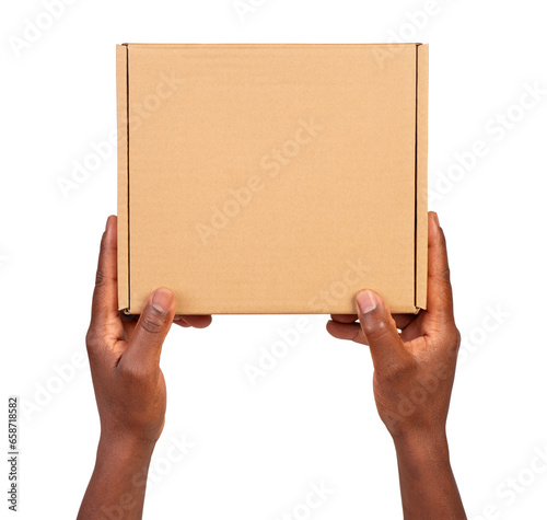 Man holding a small cardboard box isolated on white or transparent background © photka