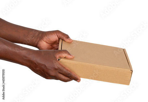 Man holding a cardboard box isolated on white or transparent background © photka