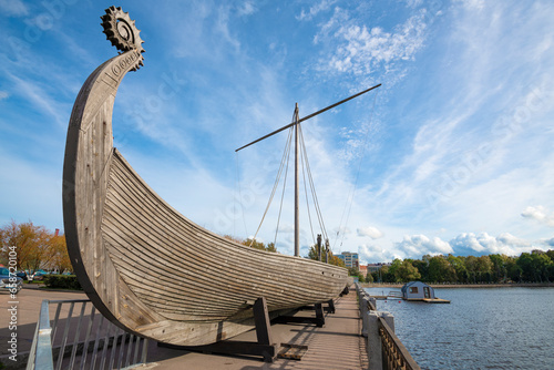 Viking longship close-up on a sunny September day. City embankment of Vyborg photo