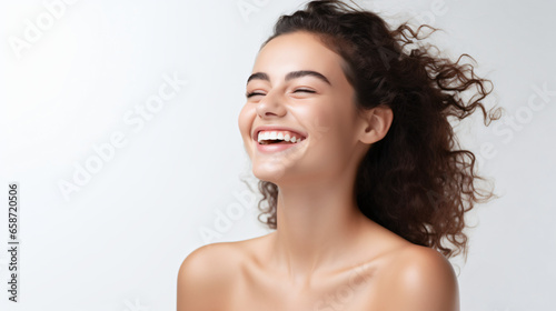 Beauty skin. Head and shoulders of woman model, touching glowing, hydrated facial skin, apply toner, skin cream or lotion for healthy look, after shower portrait, white background. photo