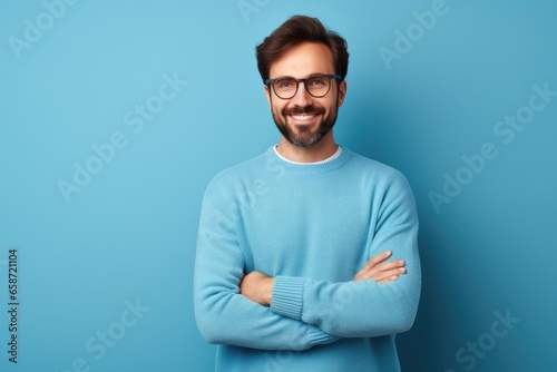 A confident man with a beard and glasses standing with arms crossed © pham