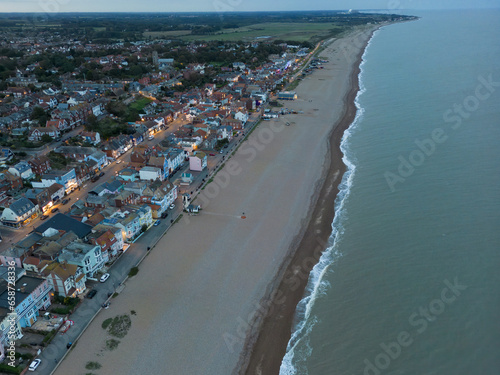 Dramatic aerial view of a dusk view of the popular Suffolk coastal town of Aldeburgh. Showing the orange street lights and lit dwellings. photo