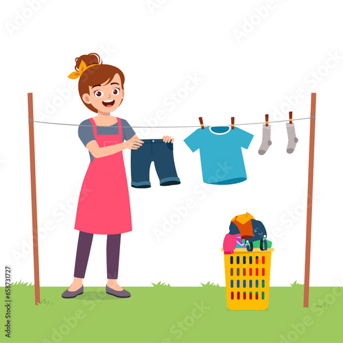 young woman hanging wet clothes outside