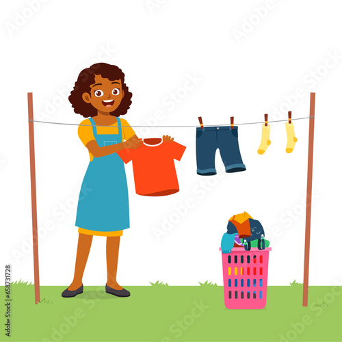 young woman hanging wet clothes outside