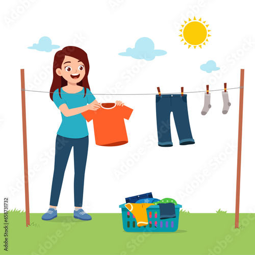 young woman hanging wet clothes outside