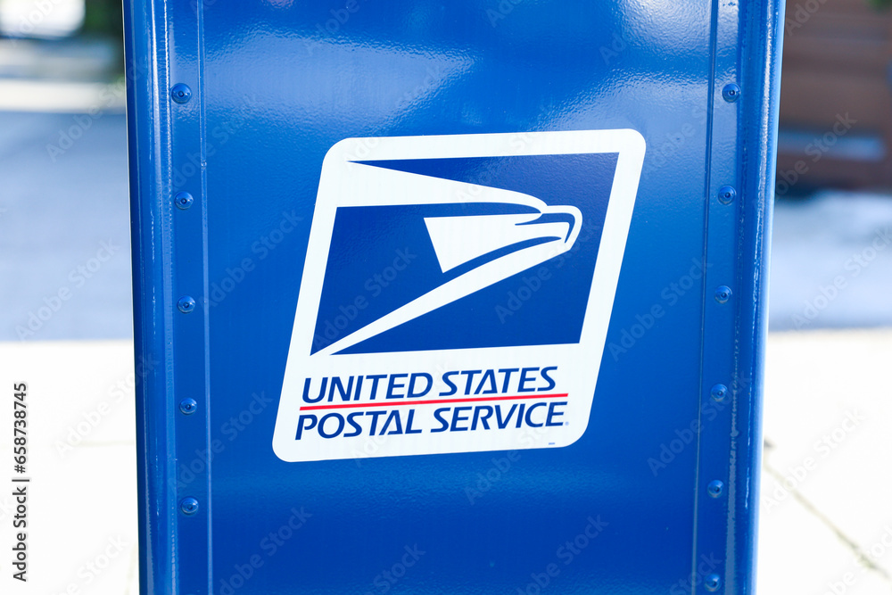 Boston, MA, USA, October, 7th 2023, USPS sign and mailbox and truck on