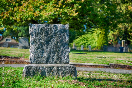 Large blank tombstone in cemetery.