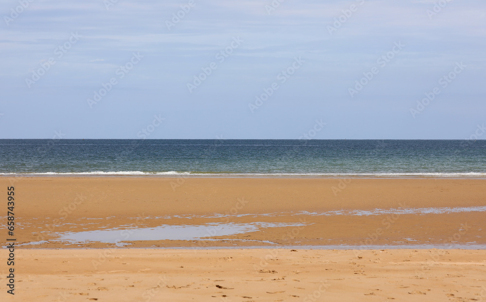 background with blue sky blue sea and golden sand ideal for personalizing with a text