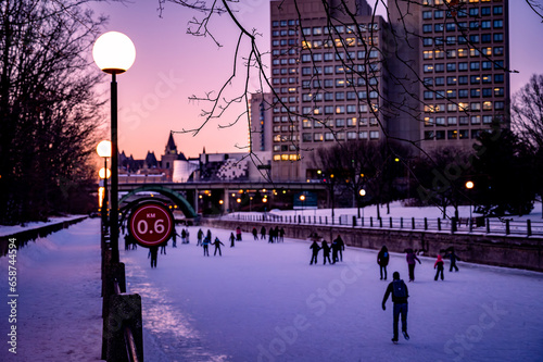 People skating on Rideau Canal Skateway, dusk, winter, Ottawa, Ontario, Canada photo