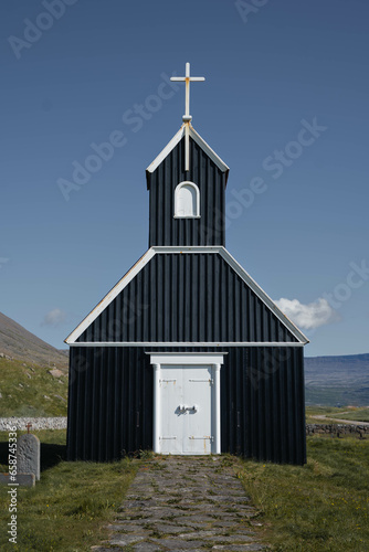 Black, red and white church in the middle of nowhere